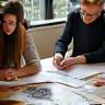 Designers in a creative meeting reviewing client concepts