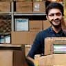 Happy staff preparing printed orders for delivery to client